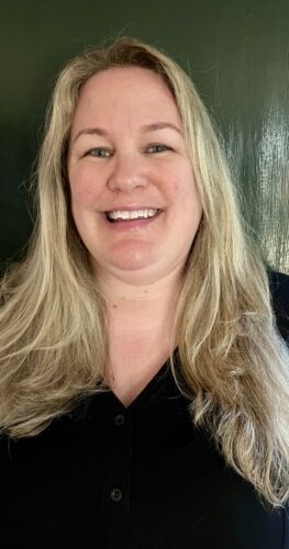 Ariel Perloff, PsyD smiling warmly in a photo with a soft green background.